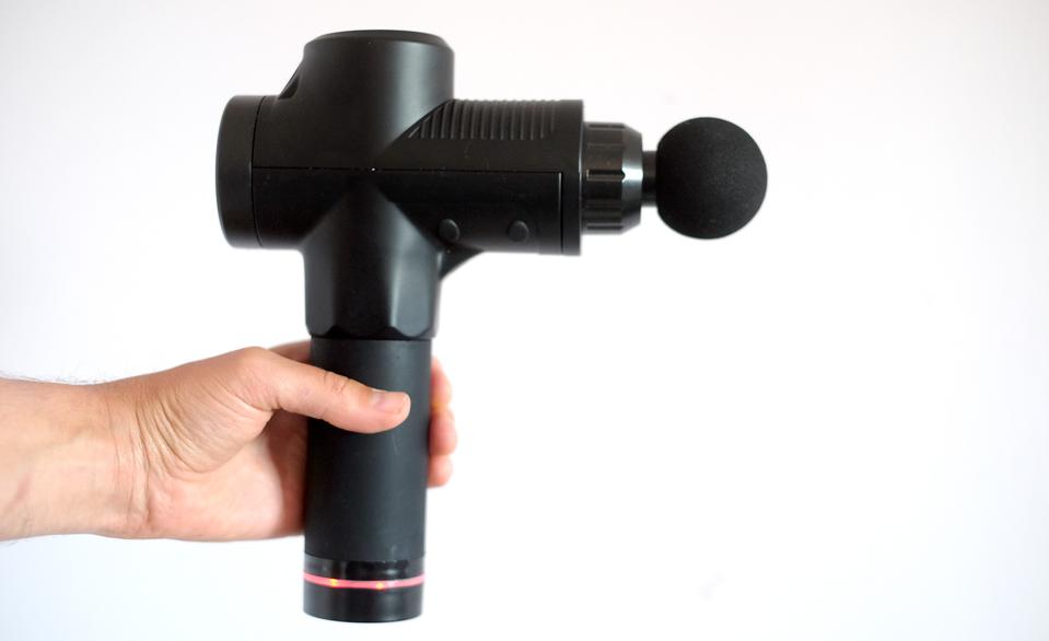 A Hirix-branded massage gun held in the hand.