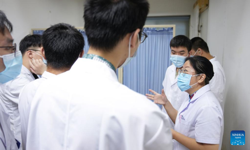 Zhang Lin (R, front) instructs interns at a Traditional Chinese Medicine hospital in Beijing, capital of China, Sept. 7, 2022. (Xinhua/Ju Huanzong)